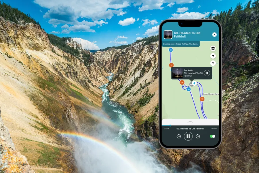 Smartphone displaying the Shaka Guide app over a dramatic canyon with a rushing river, steep rocky walls, and a rainbow rising from waterfall mist.