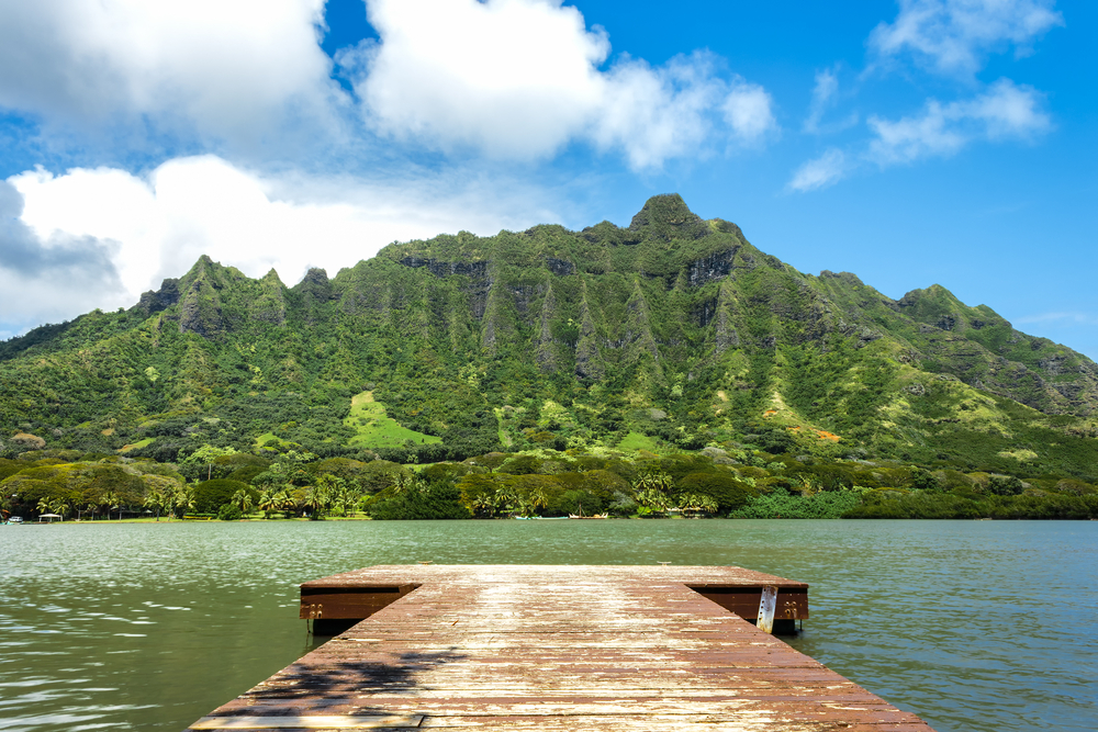 A pier on Moli?i Fishpond looking toward the Ko?olau Mountain Range at Kualoa Ranch on Oahu, Hawaii