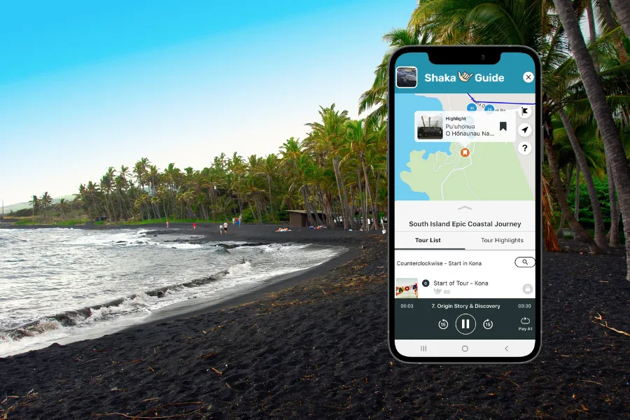 Smartphone displaying the Shaka Guide app over a tropical black sand beach lined with palm trees and gentle ocean waves.