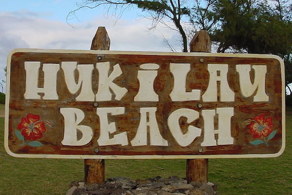 Hukilau Beach sign / Cumulus Clouds, CC BY-SA 3.0, via Wikimedia Commons