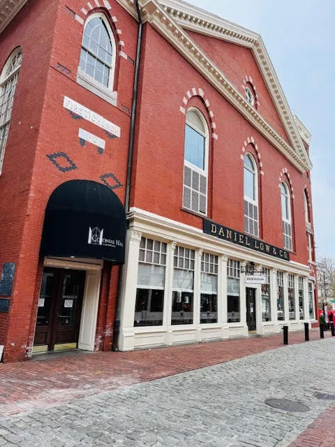 Historic red-brick building with arched windows, home to Daniel Low & Co. and Rockafellas restaurant in Salem, Massachusetts.