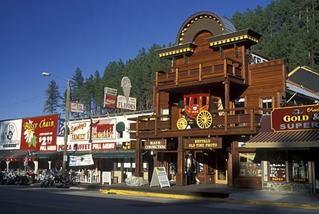Downtown Keystone, South Dakota, featuring western-style wooden storefronts, restaurants, and souvenir shops along the main street.