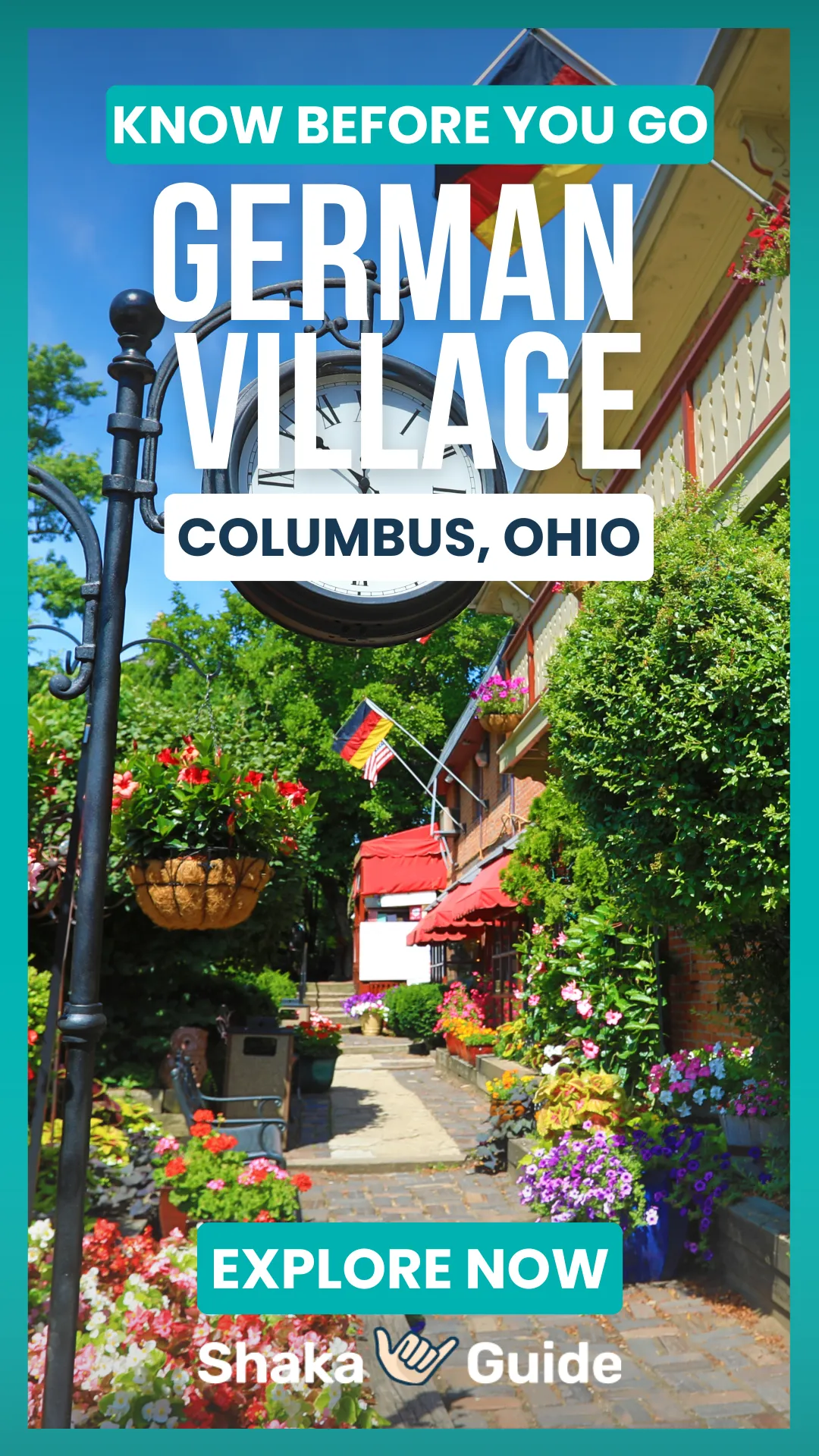 A vertical promotional graphic for Shaka Guide featuring a charming summer streetscape in German Village, Columbus, Ohio. A black ornamental street clock and hanging flower baskets are visible in the foreground, with a cobblestone walkway lined with colorful blooming flowers, lush greenery, red awnings, and German and American flags leading toward brick storefronts in the background. Bold text overlays read "Know Before You Go — German Village — Columbus, Ohio — Explore Now." The Shaka Guide logo appears at the bottom.