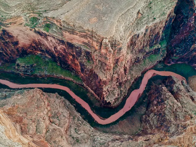 Aerial view of the Little Colorado River snaking through steep red rock cliffs near the Grand Canyon's South Rim.