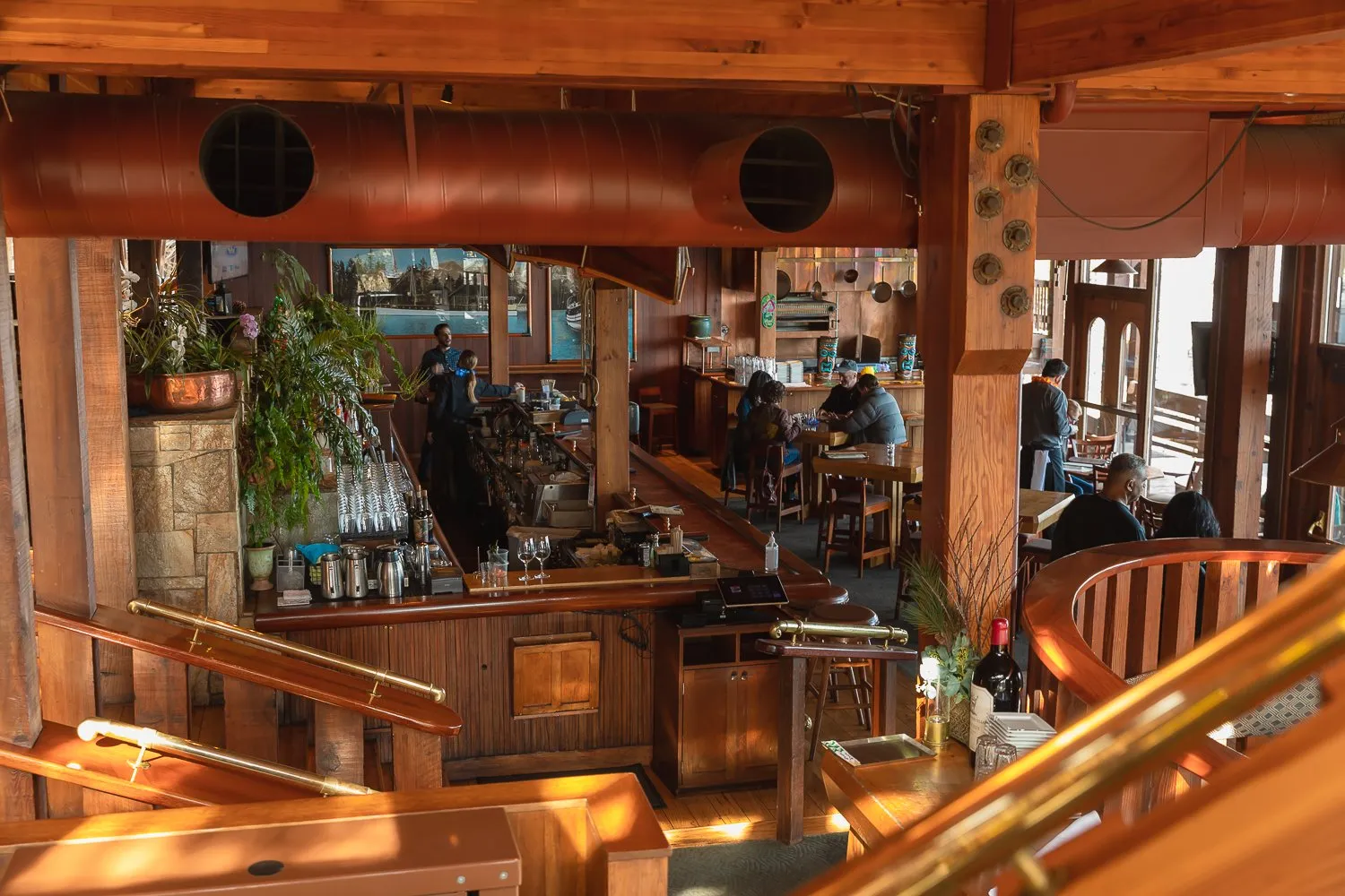 Interior view of Jake's on the Lake restaurant, showing a bar area and dining tables with patrons enjoying their meals.