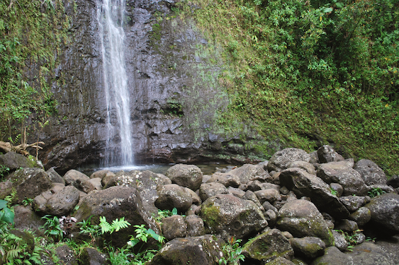 a waterfall with rocks at the bottom