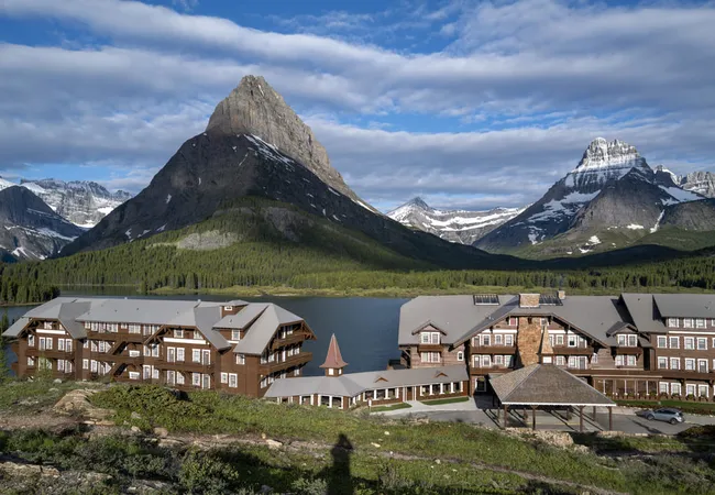 Many Glacier Hotel rests along Swiftcurrent Lake, surrounded by towering mountain peaks and alpine scenery.