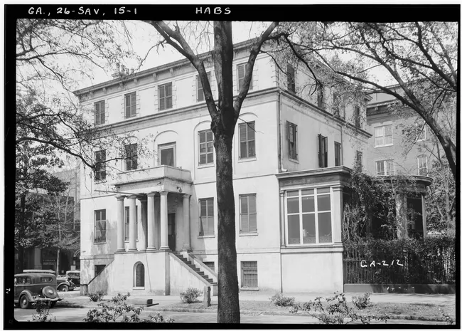 Historic Juliette Gordon Low Birthplace, featuring a large two-story structure with columns and surrounding greenery.