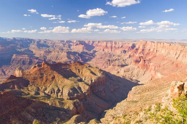 Expansive view from Navajo Point on the Grand Canyon’s South Rim, with layered red rock formations glowing in the sun.