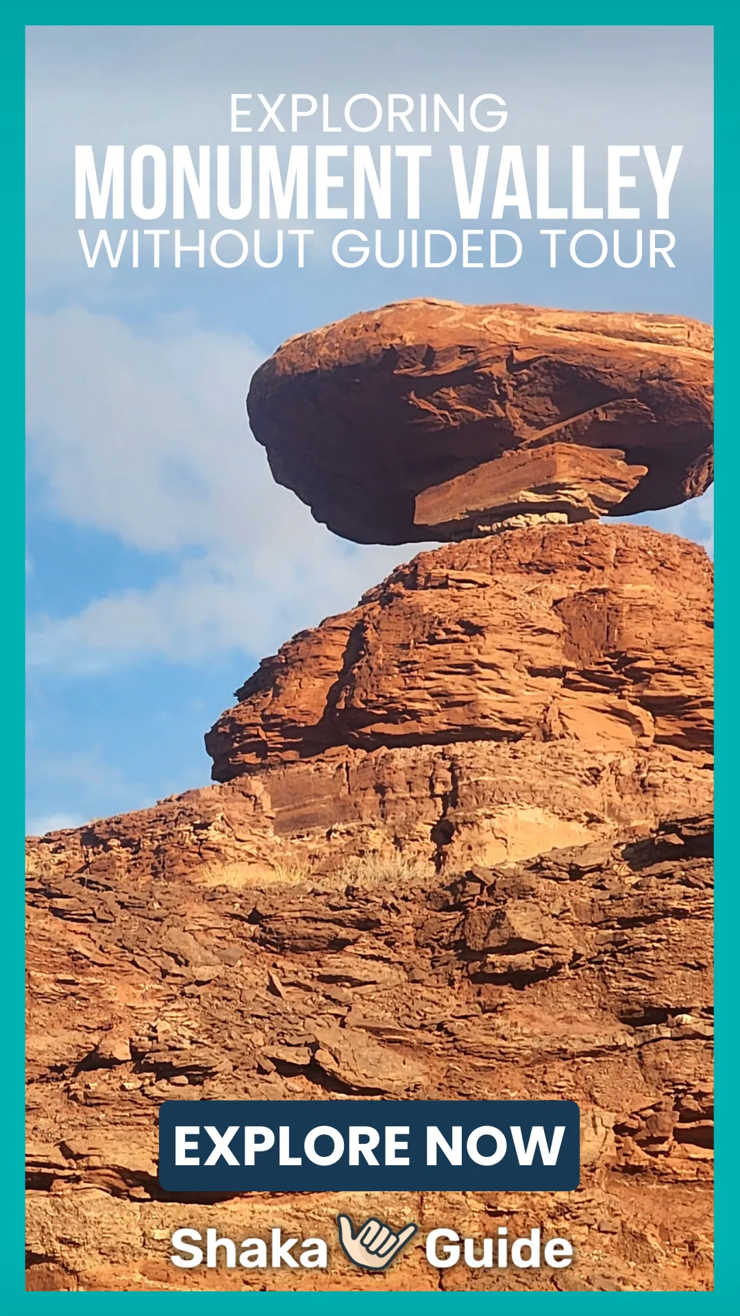 Balanced rock formation perched atop layered red sandstone under a blue sky in Monument Valley.