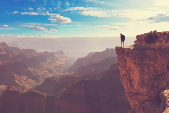 hiker above grand canyon south rim overlook