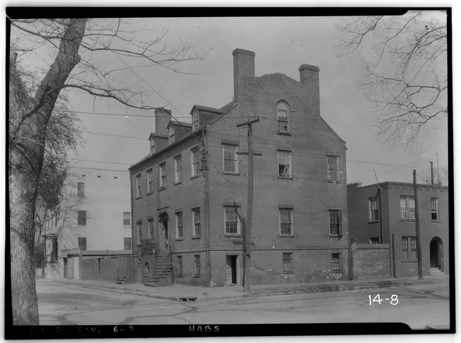 Historic Davenport House, a brick building captured in a black and white photo, showcasing its architectural features and surroundings.