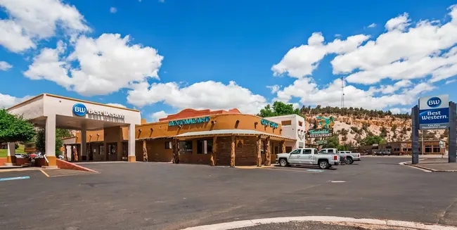 Exterior of Best Western hotel in Kanab, Utah, with attached restaurant and parked pickup trucks.