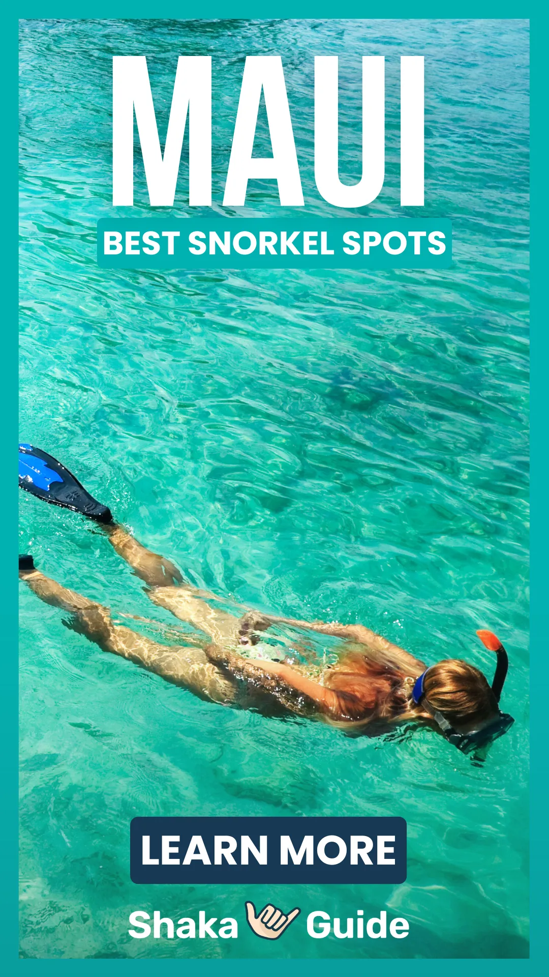 Woman snorkeling in clear turquoise Maui water with bright sunlight illuminating the shallow reef below.
