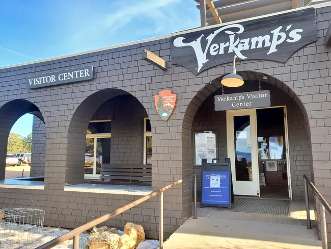 The entrance to Verkamp’s Visitor Center features brown brick arches and National Park Service signage.