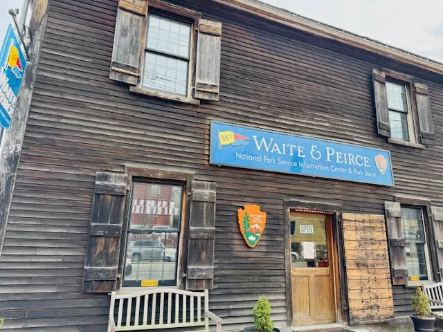 Front of Waite & Peirce store in Salem, Massachusetts, with rustic wooden exterior and National Park Service signage.